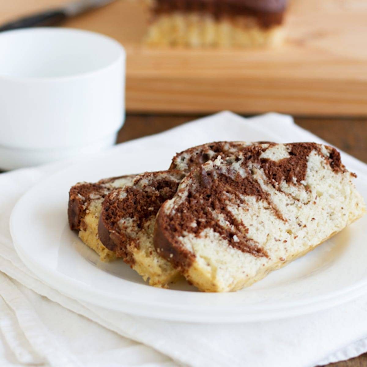 Chocolate and sweet cream marble loaf stacked on a plate.